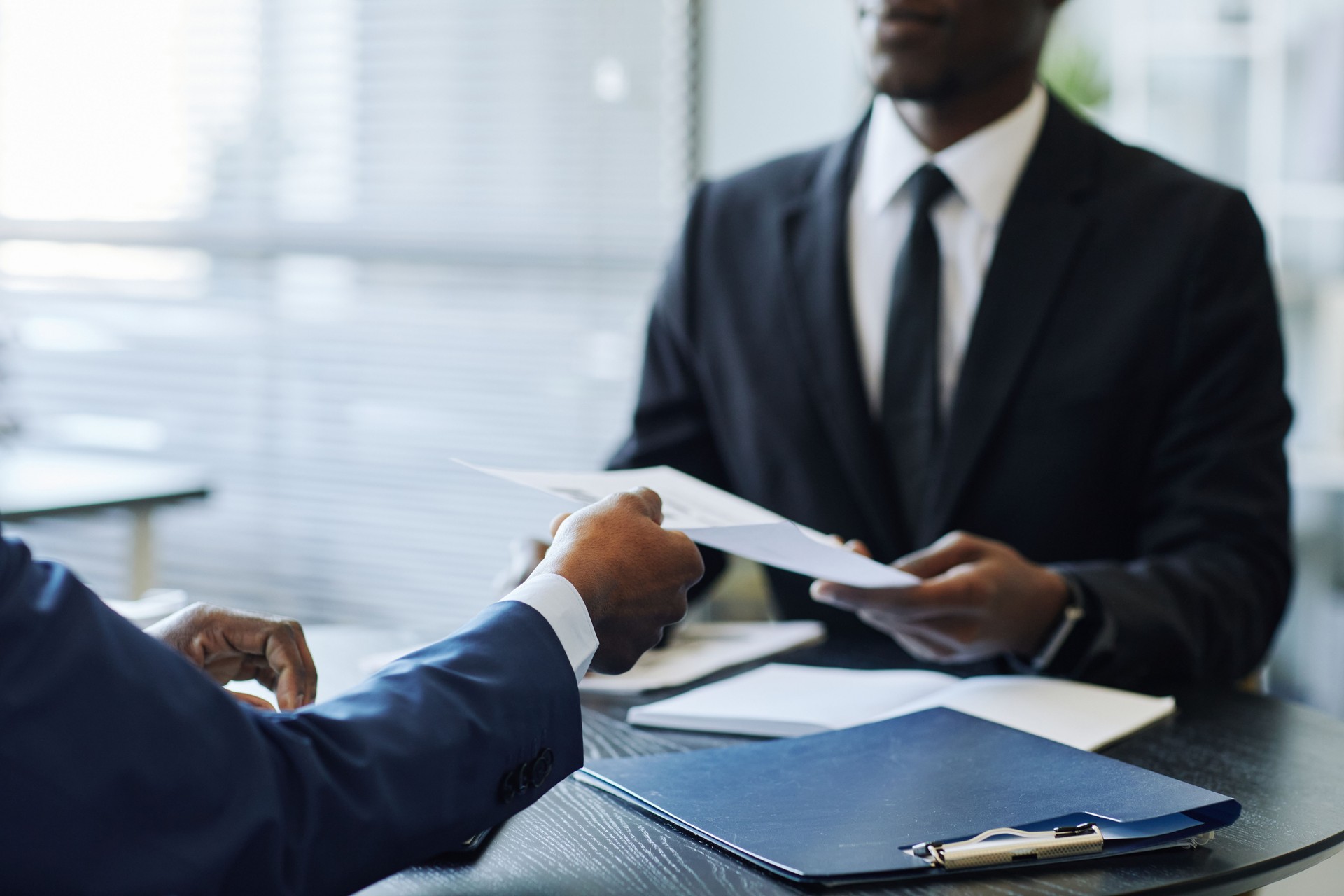 Business Partners Discussing Contract Closeup